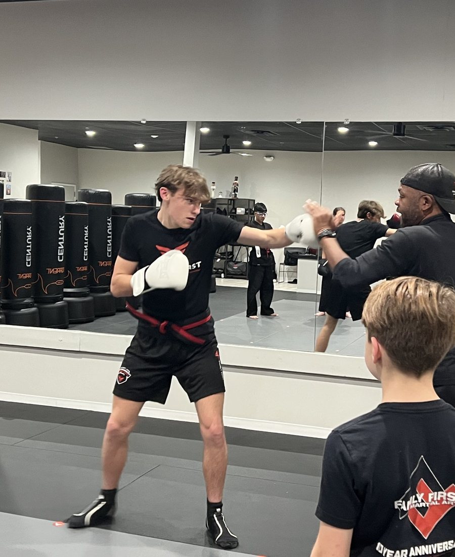 Teen Gladiators student boxing with a coach