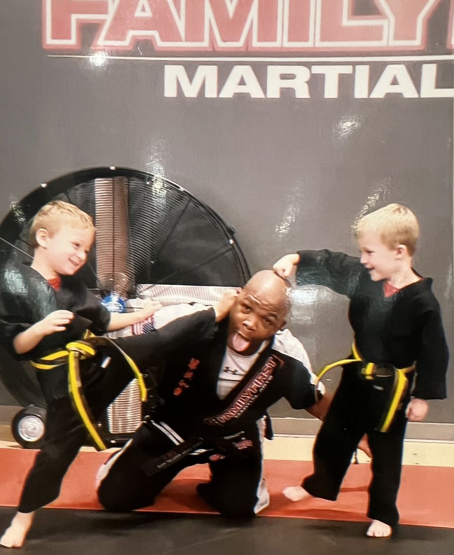 Coach celebrating with young students